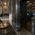 Congressional hearing room with U.S. documents and a dollar coin in the foreground as a woman pays by phone, symbolizing stablecoins becoming easier to use while Bitcoin still awaits regulatory clarity